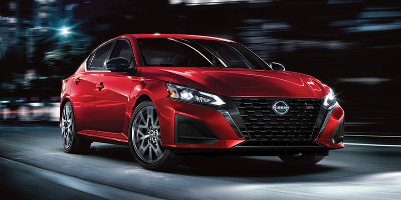 red Nissan rental car front view