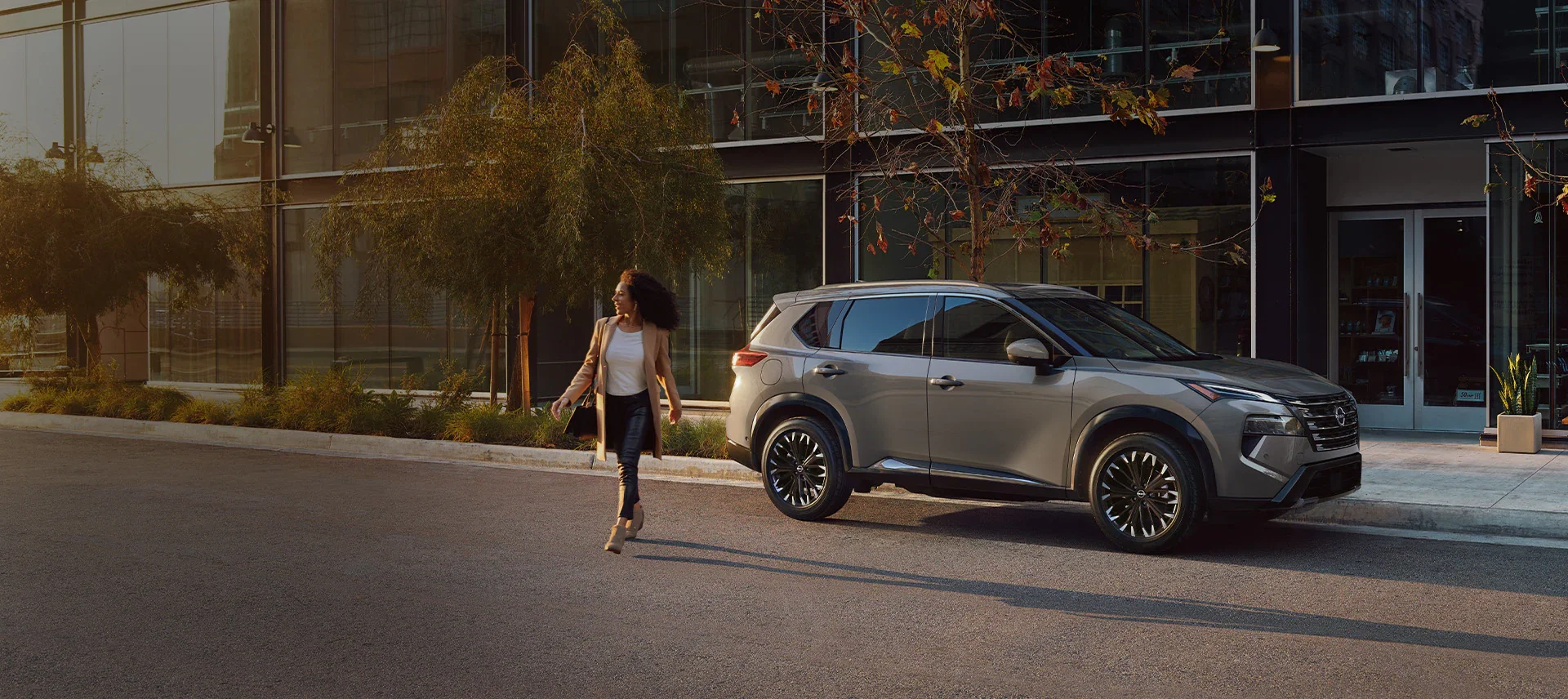 Woman walking away from a 2025 Nissan Rogue
