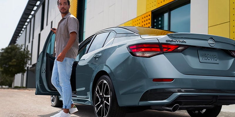 Guy standing next to a 2025 Nissan Sentra