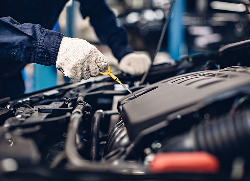 Mechanic inspecting engine components during service