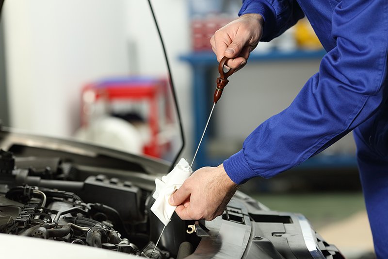 Technician performing engine diagnostics on a vehicle